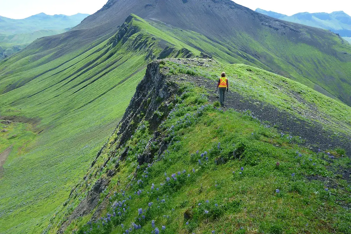 Geologist doing field work on a mountain ridge